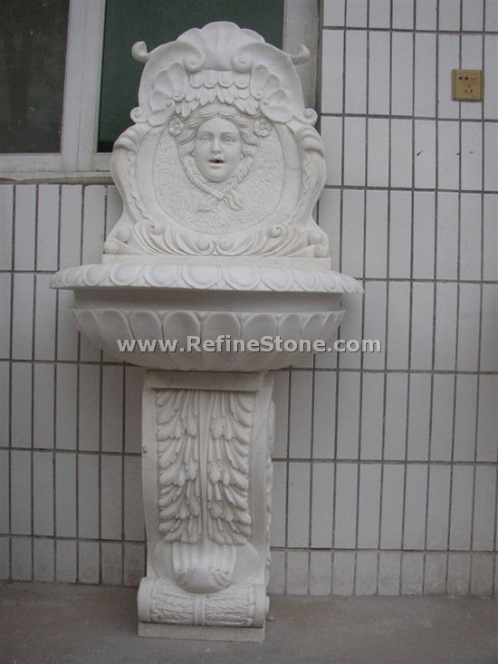 Carved girl head water fountain